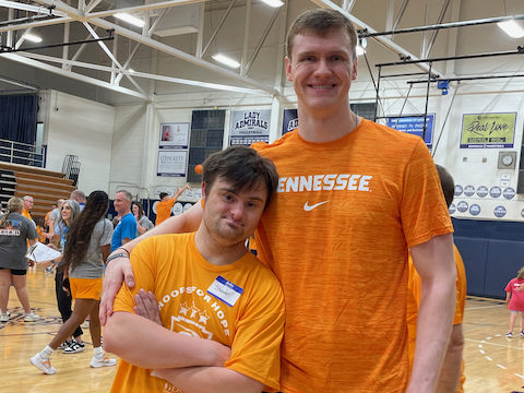 Hoops for Hope participant, Shawen Rampold, standing with student athlete Colin Coyne.