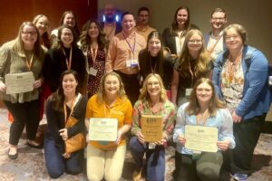 Group of department faculty and graduate students gathered at the SRAAAE Conference